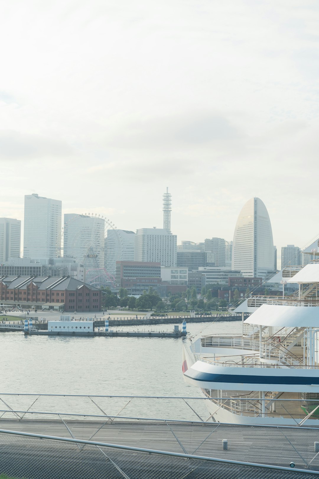 white boat on water near city buildings during daytime