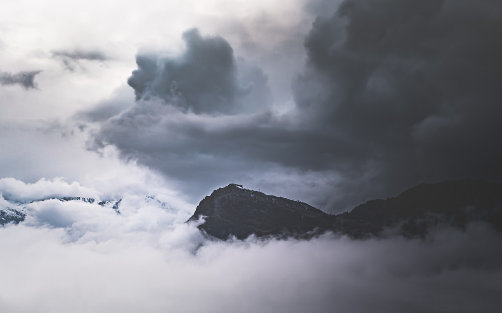 black mountain under white clouds