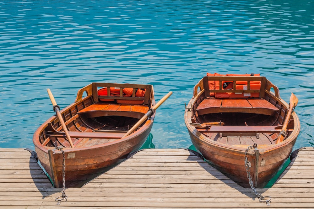 brown wooden boat on dock during daytime