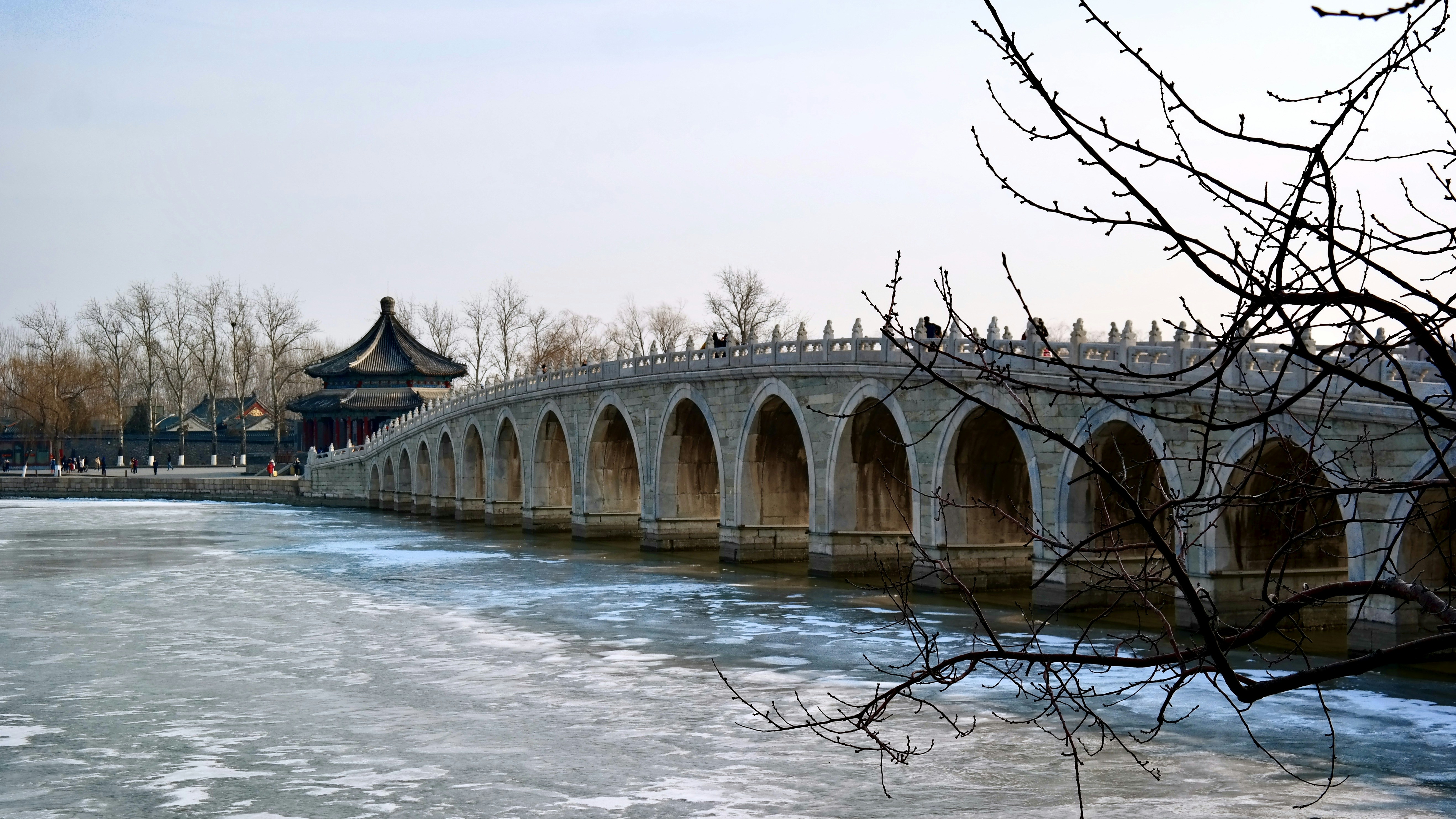 brown concrete bridge over body of water during daytime
