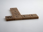 brown wooden letter blocks on white surface