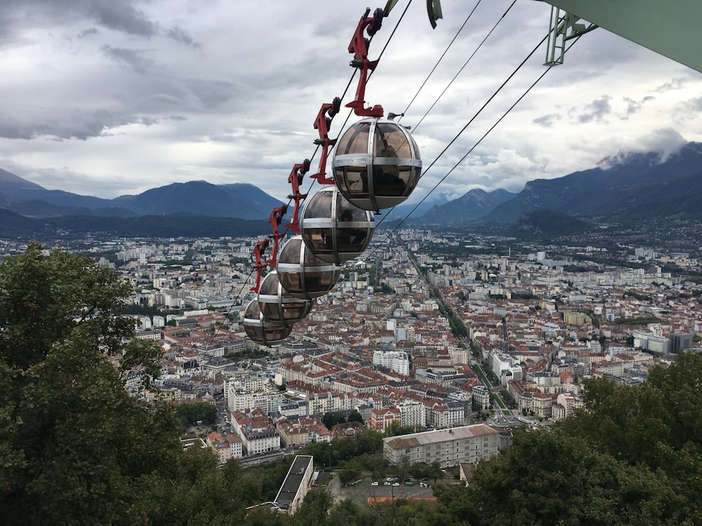 red and black cable car over city during daytime