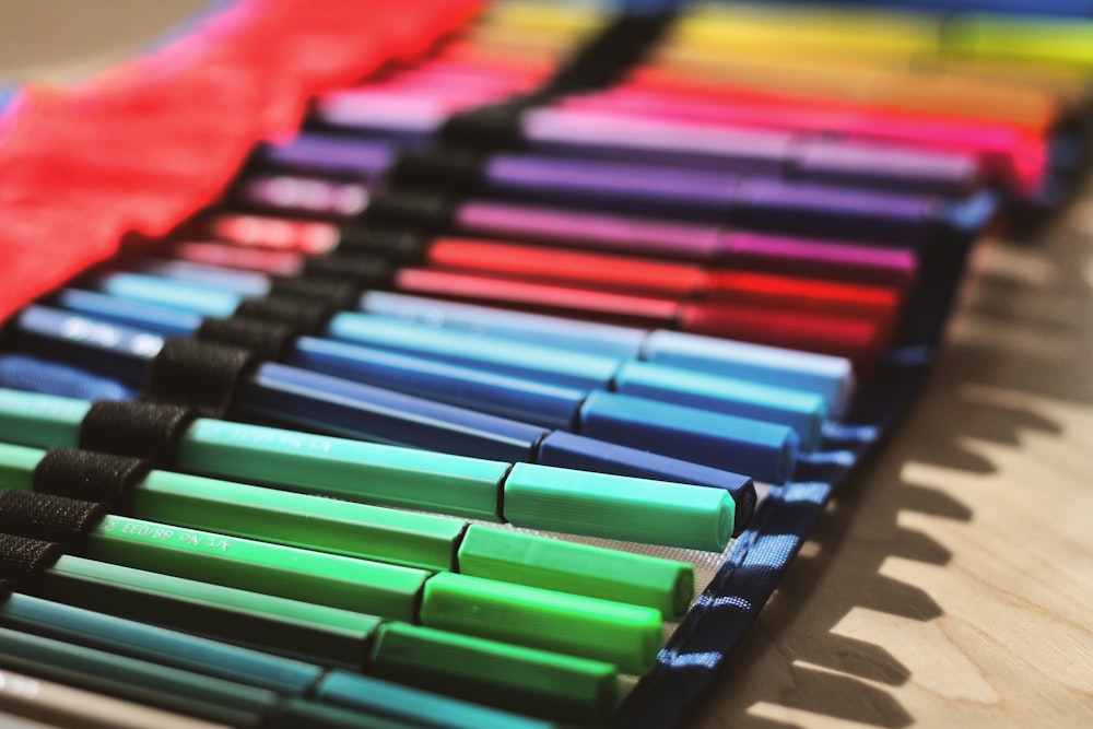 multi colored coloring pencils on brown cardboard box photo