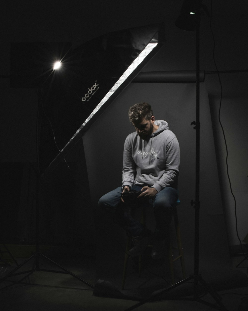 man in gray sweater sitting on black chair