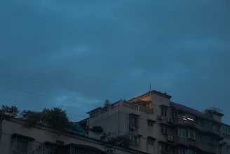 Evening exterior shot of apartments with warm lighting and natural surroundings.