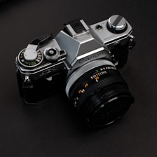 black and silver nikon dslr camera