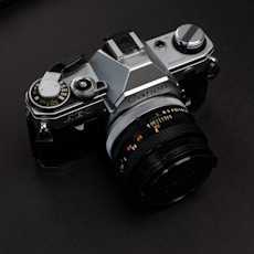 black and silver nikon dslr camera
