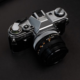 black and silver nikon dslr camera