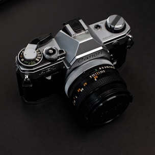 black and silver nikon dslr camera