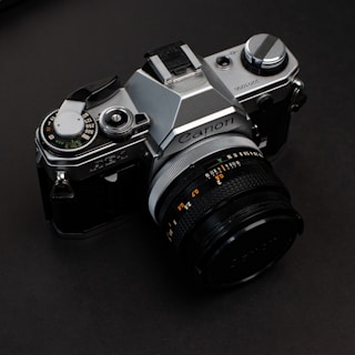 black and silver nikon dslr camera