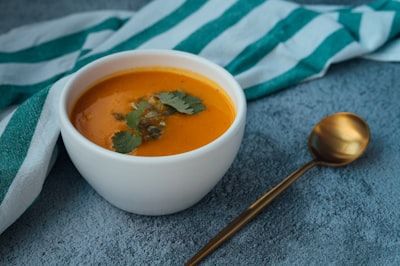 soup in white ceramic bowl gravy teams background