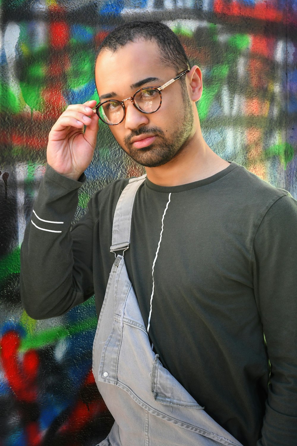 man in black crew neck shirt wearing black framed eyeglasses