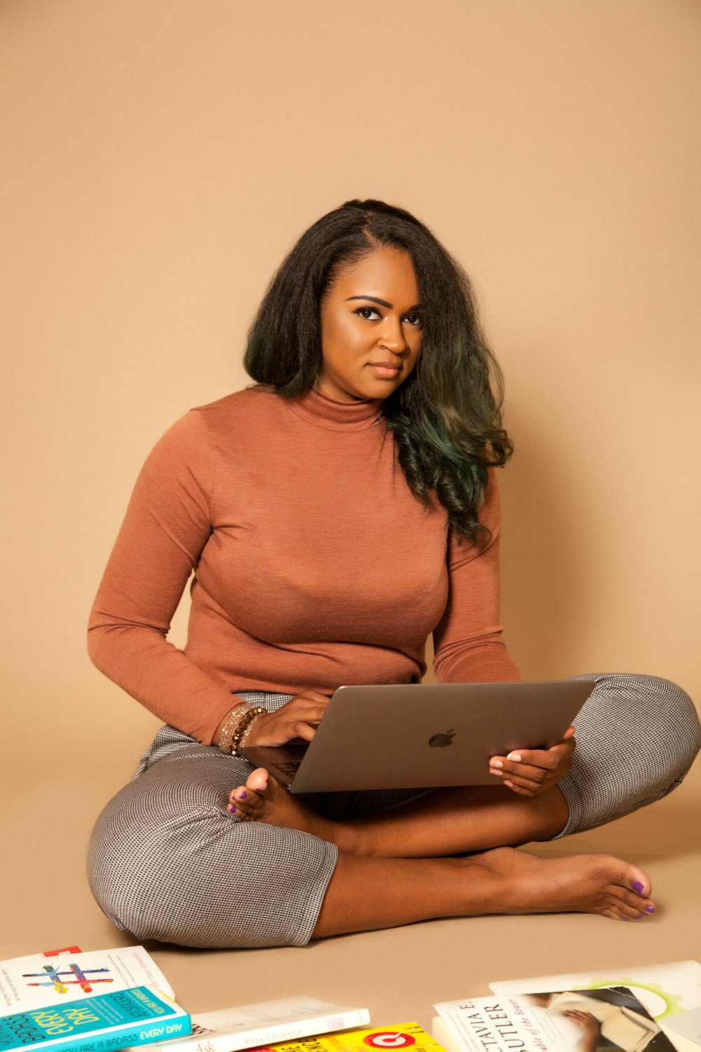 woman in brown long sleeve shirt and gray pants sitting on gray couch