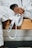 person in white dress shirt wearing black leather strap watch