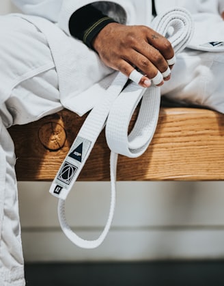 person in white dress shirt wearing black leather strap watch