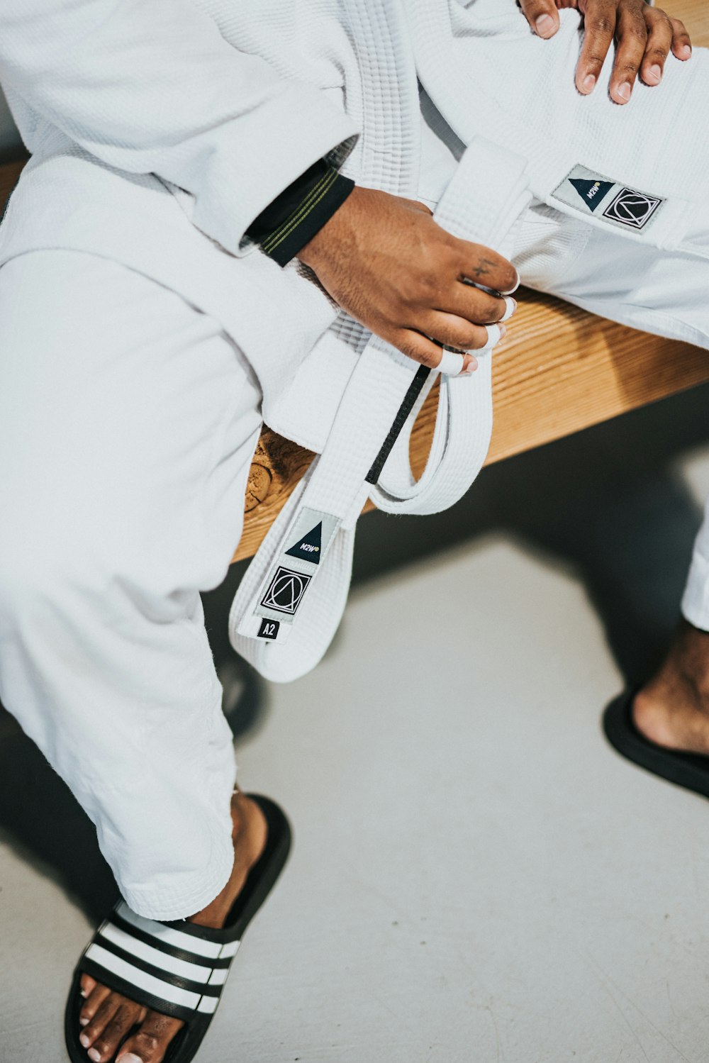 person in white pants and brown leather belt