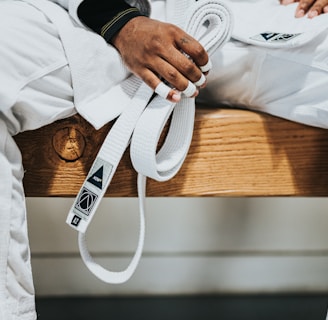 person in white dress shirt holding white plastic bag