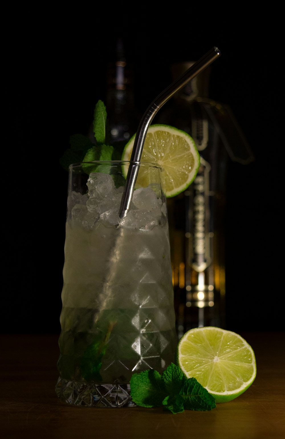 clear drinking glass with water and sliced lemon