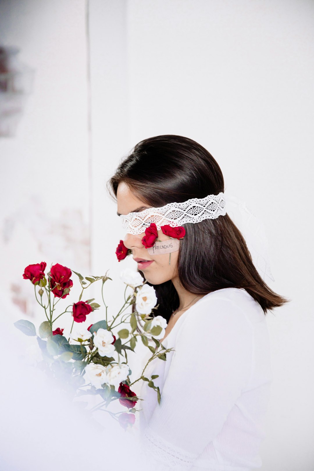 woman in white shirt wearing white and red floral headband