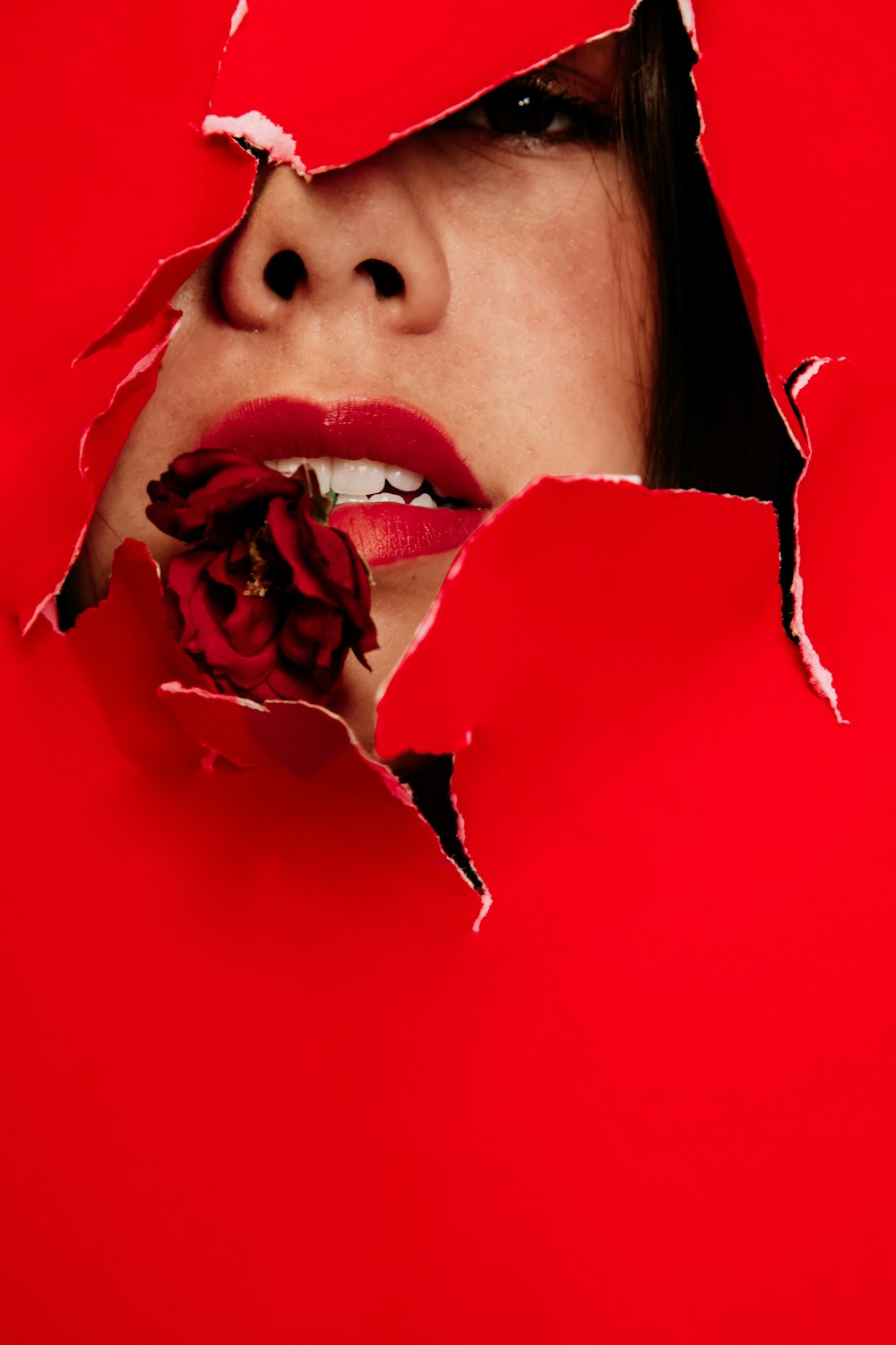 woman with red rose on her mouth