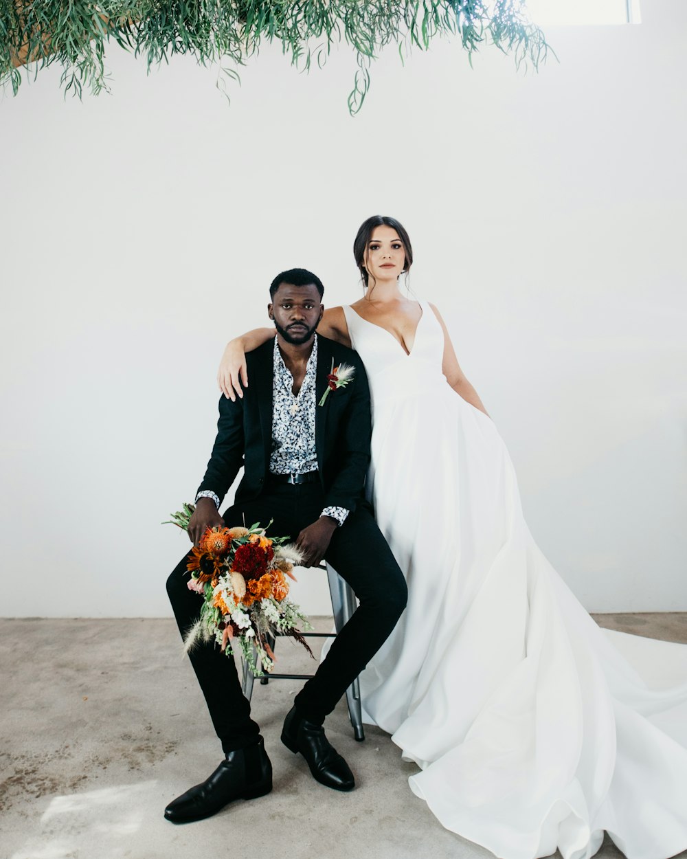 woman in white wedding gown holding bouquet of flowers