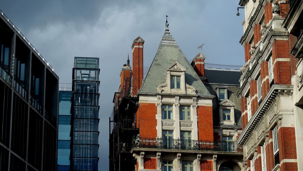 brown and white concrete building under white clouds during daytime