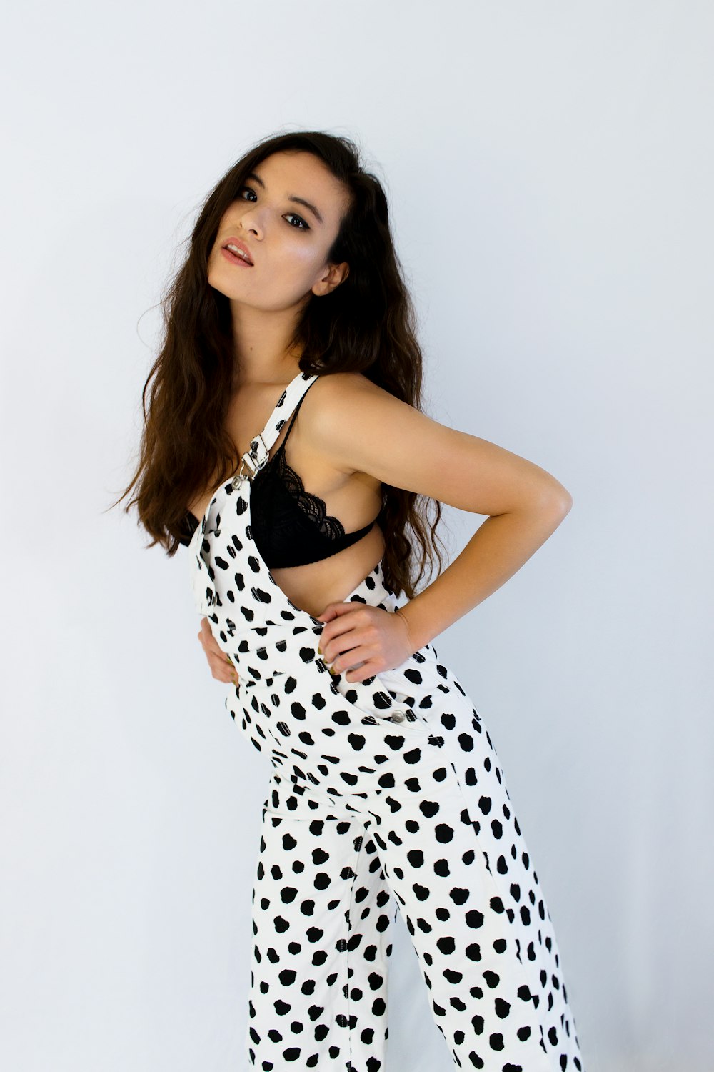 woman in black and white polka dots spaghetti strap dress