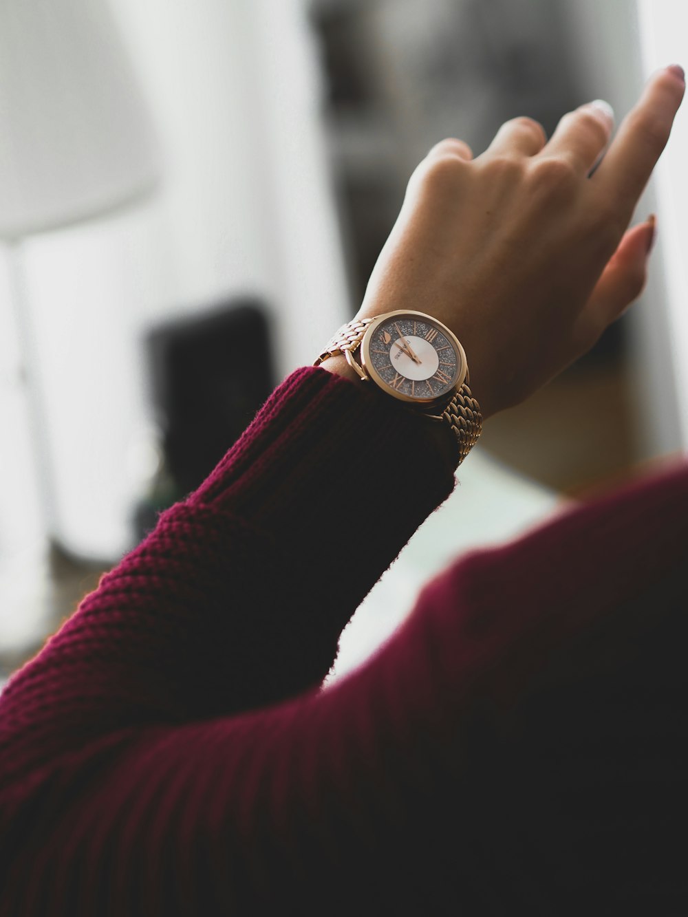 person wearing gold and white analog watch