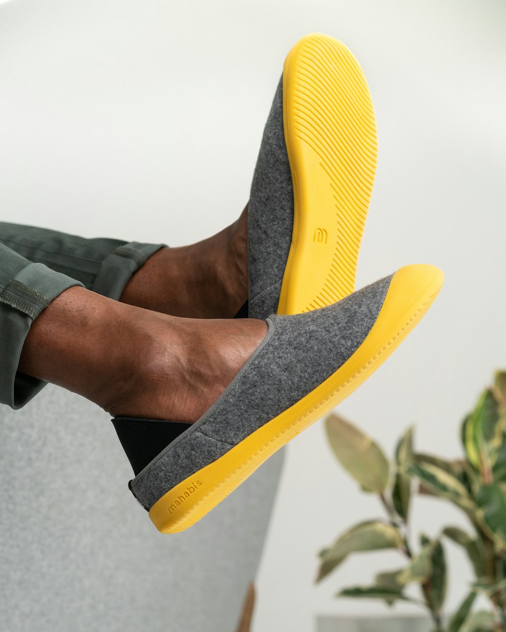 person wearing yellow and black slip on shoes
