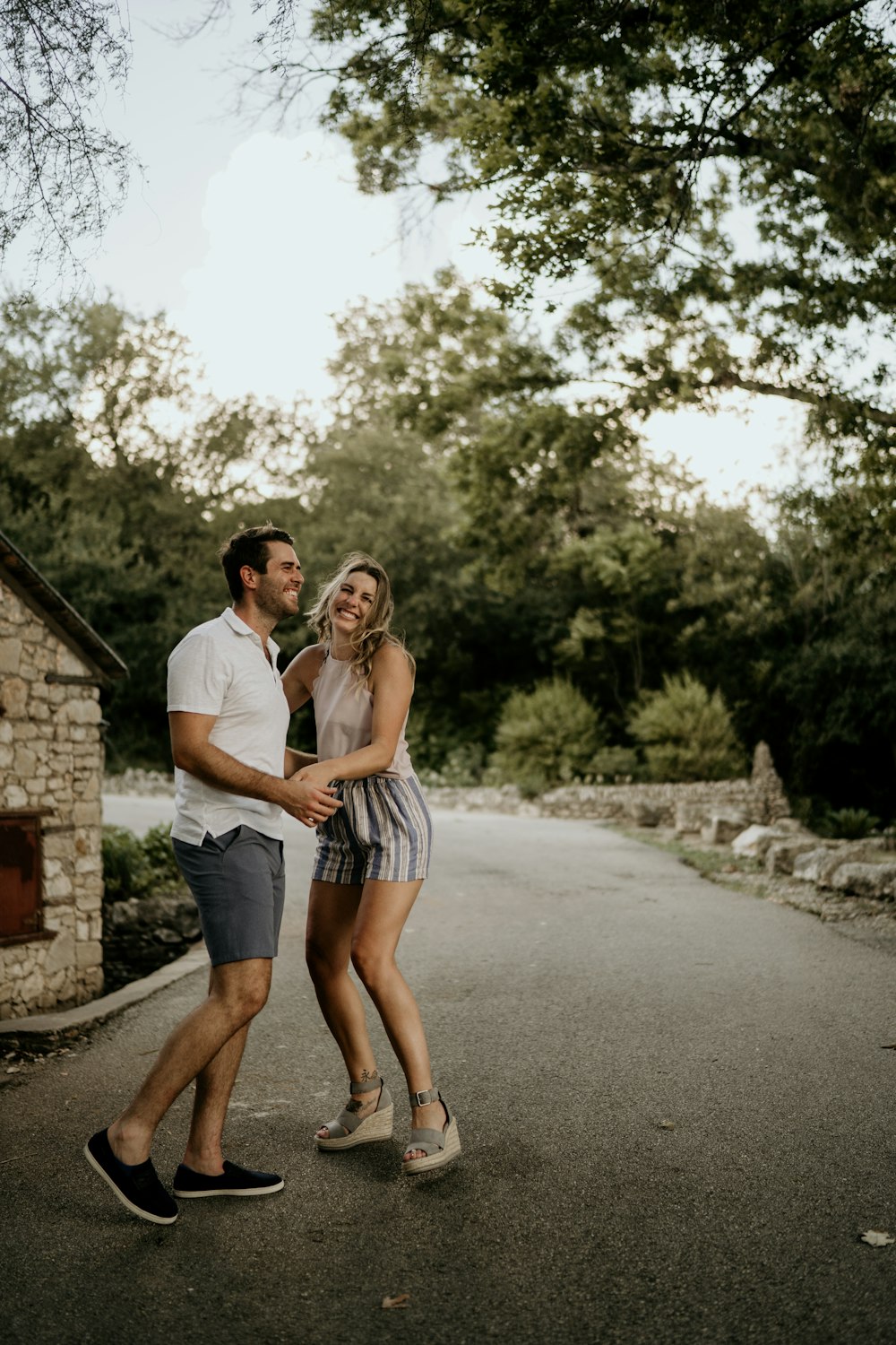 man and woman standing on road during daytime