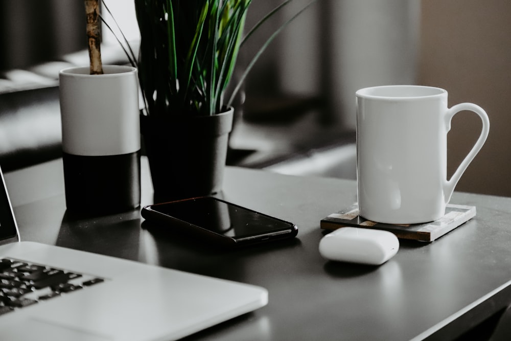 white ceramic mug on white table