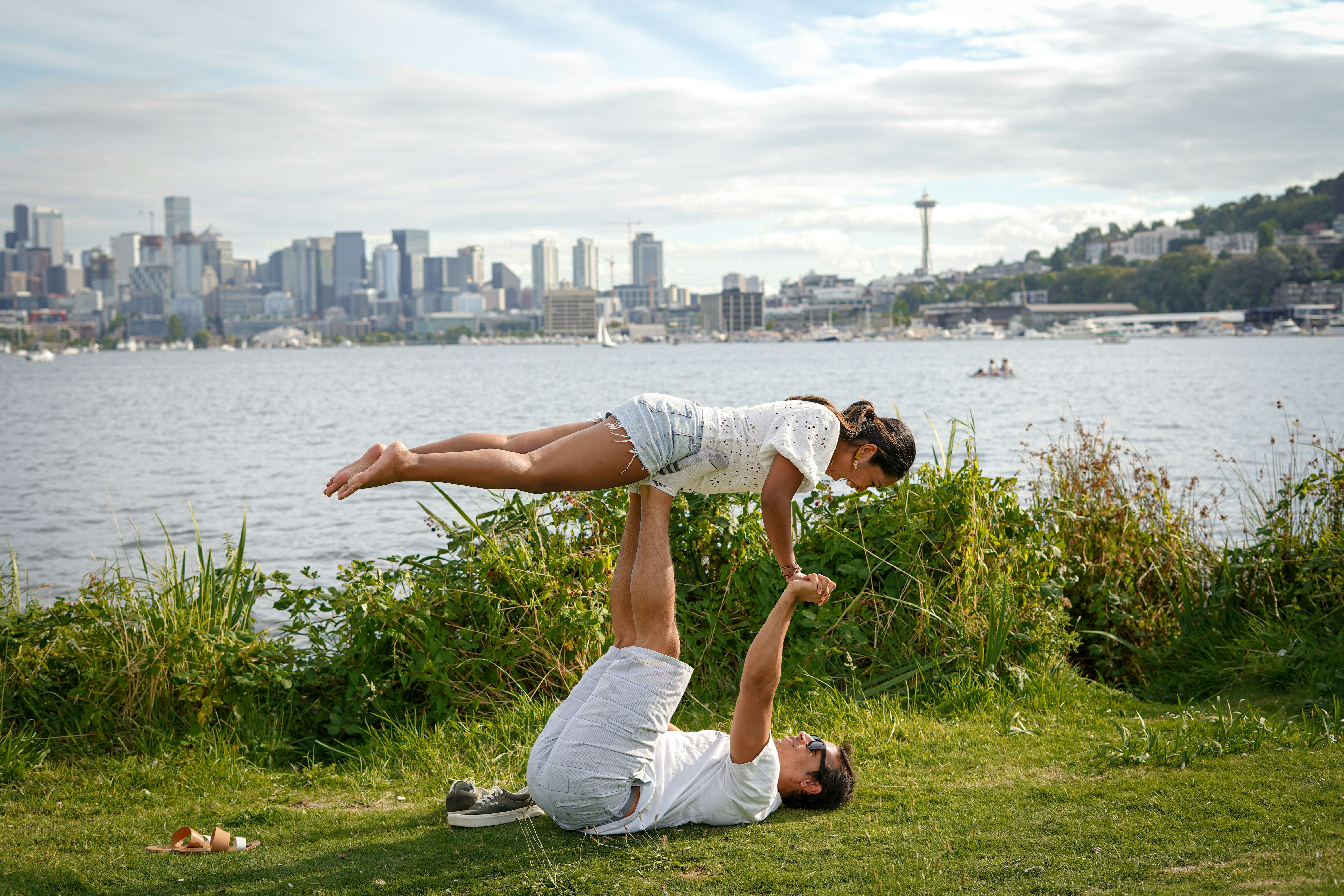 Couple doing acros yoga at Gasworks Park in Seattle, Washington