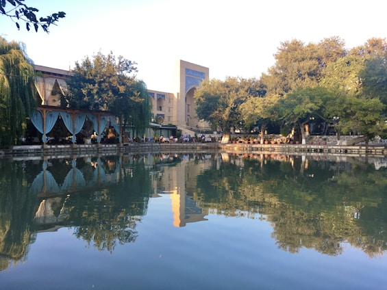 brown and white concrete building near body of water during daytime