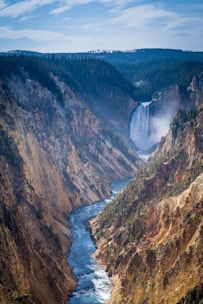 river between brown and green mountains during daytime