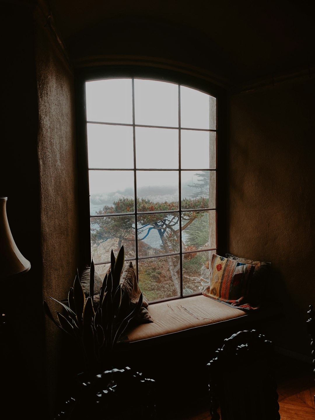 brown wooden table near window