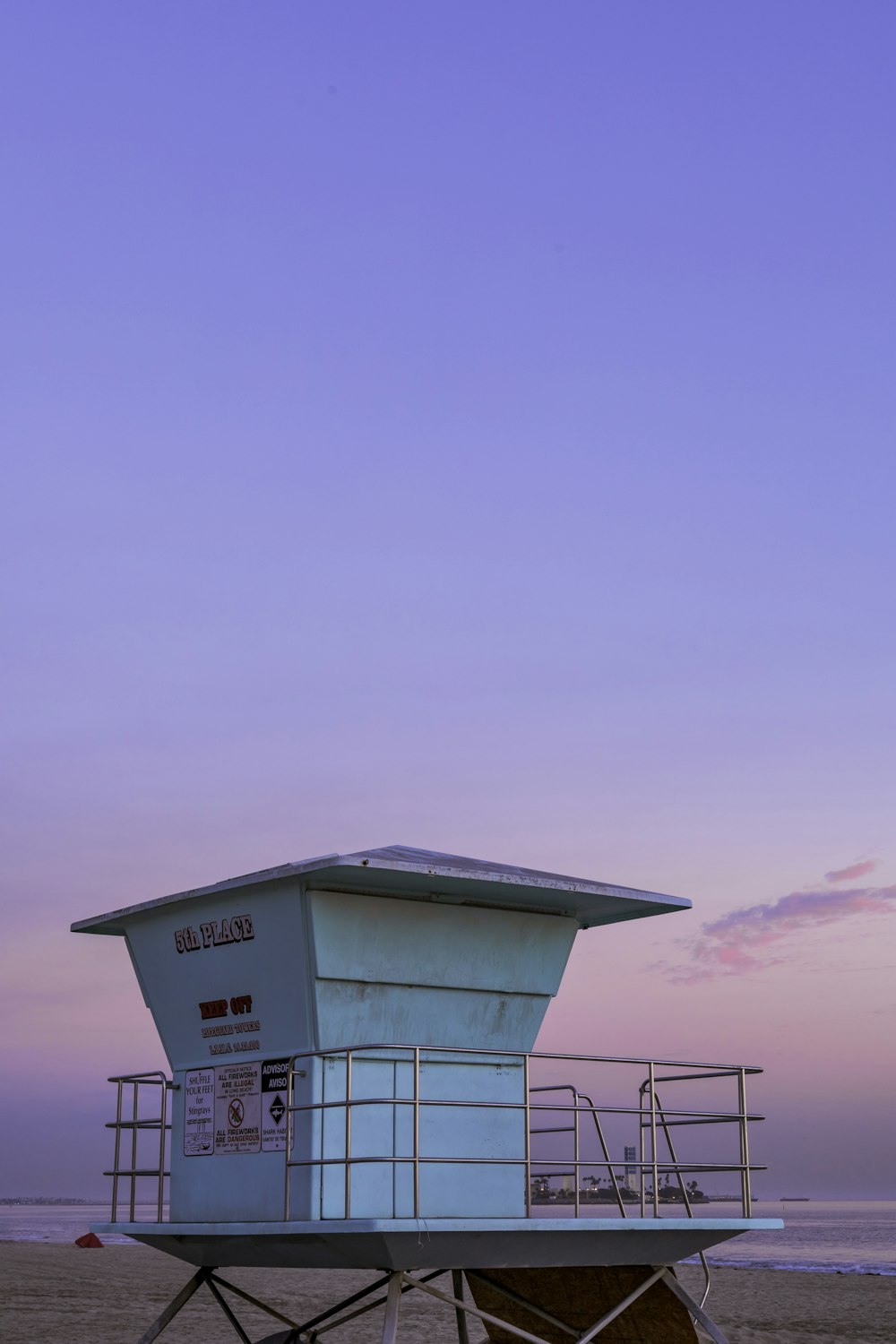 white and red lifeguard house under blue sky during daytime