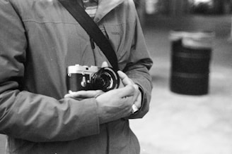 Close-up of hands photographing a vintage jacket for online sale.