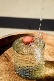 Close-up of sparkling mineral water flowing from a natural spring into a glass.