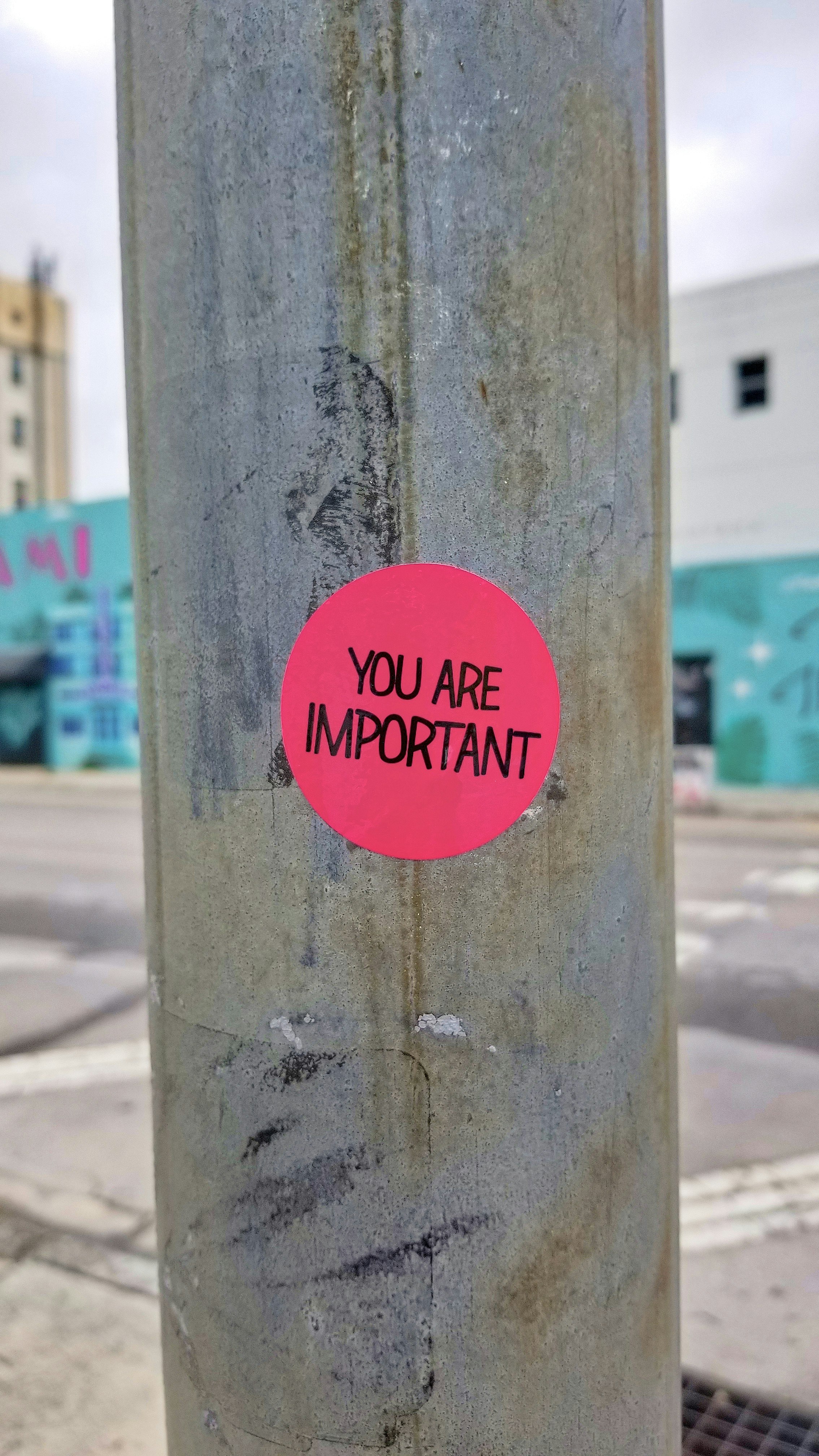 Sticker placed on a pole at the corner of a street