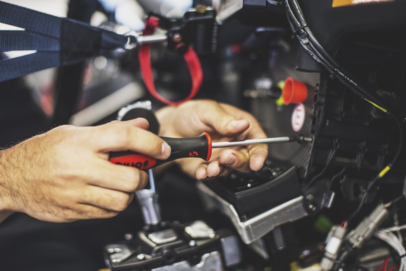 Close-up of a technician repairing a heating system with precise tools.
