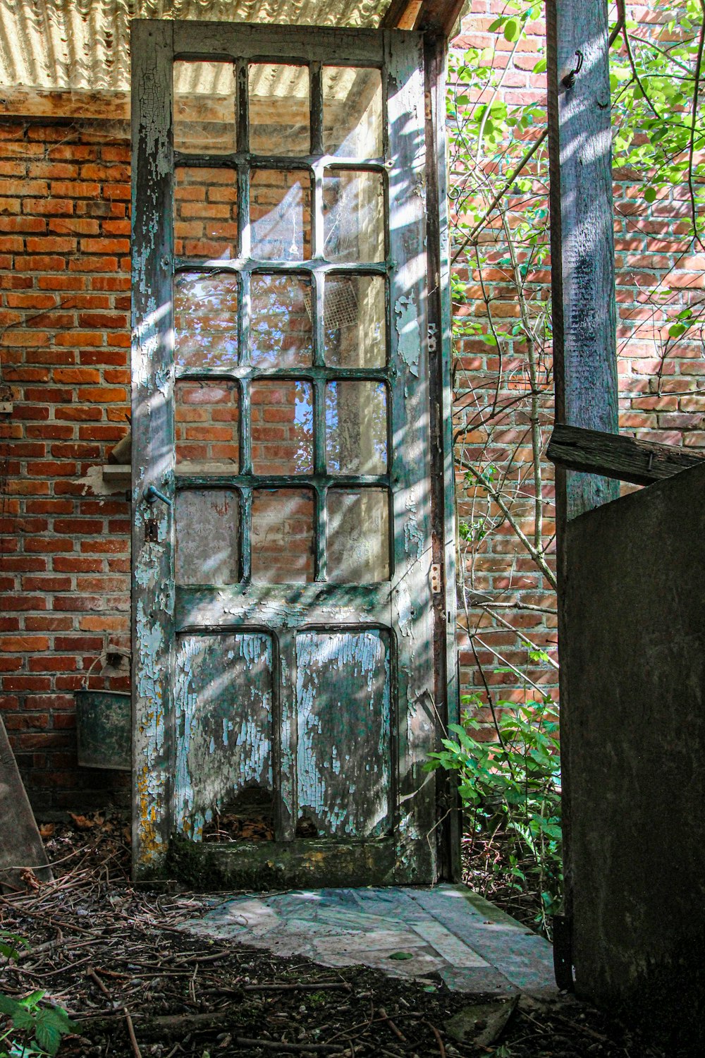 black metal door with brown brick wall
