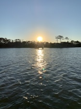 A serene sunset over calm waters symbolizing peace and reflection.