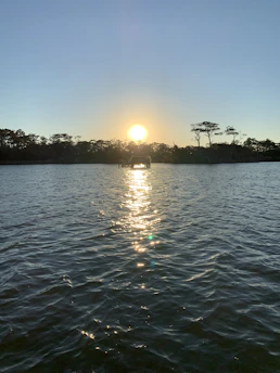 A calm sunset over a peaceful nature trail symbolizing relaxation and wellbeing.