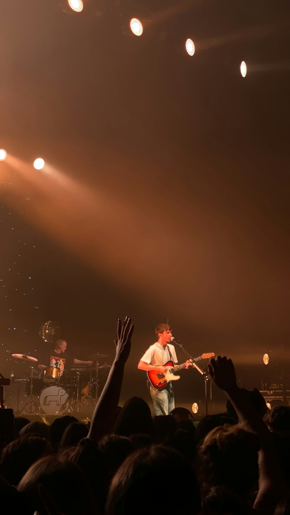 woman in red dress playing guitar on stage