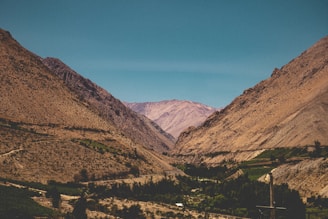 green and brown mountains under blue sky during daytime