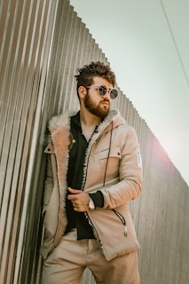 man in beige coat wearing sunglasses