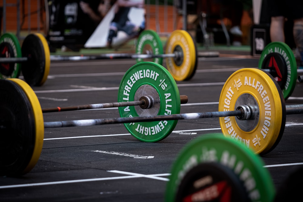 green and black dumbbell on black and white stripe textile