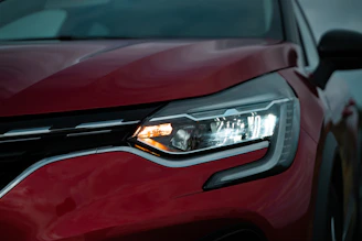 red car with silver car plate