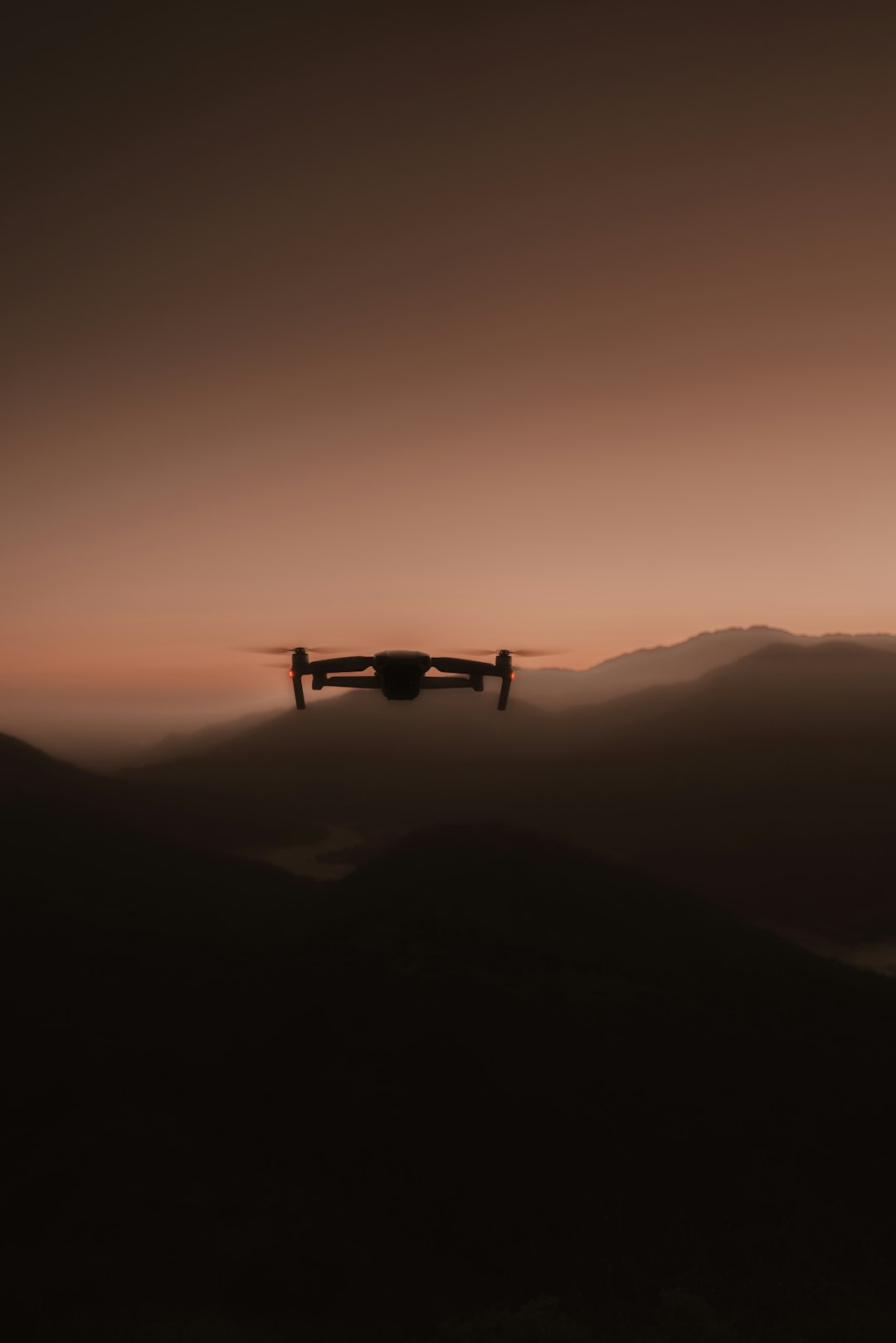 drone flying over the mountains during sunset