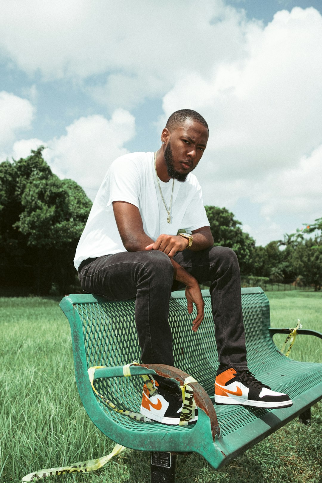 man in white crew neck t-shirt sitting on green chair